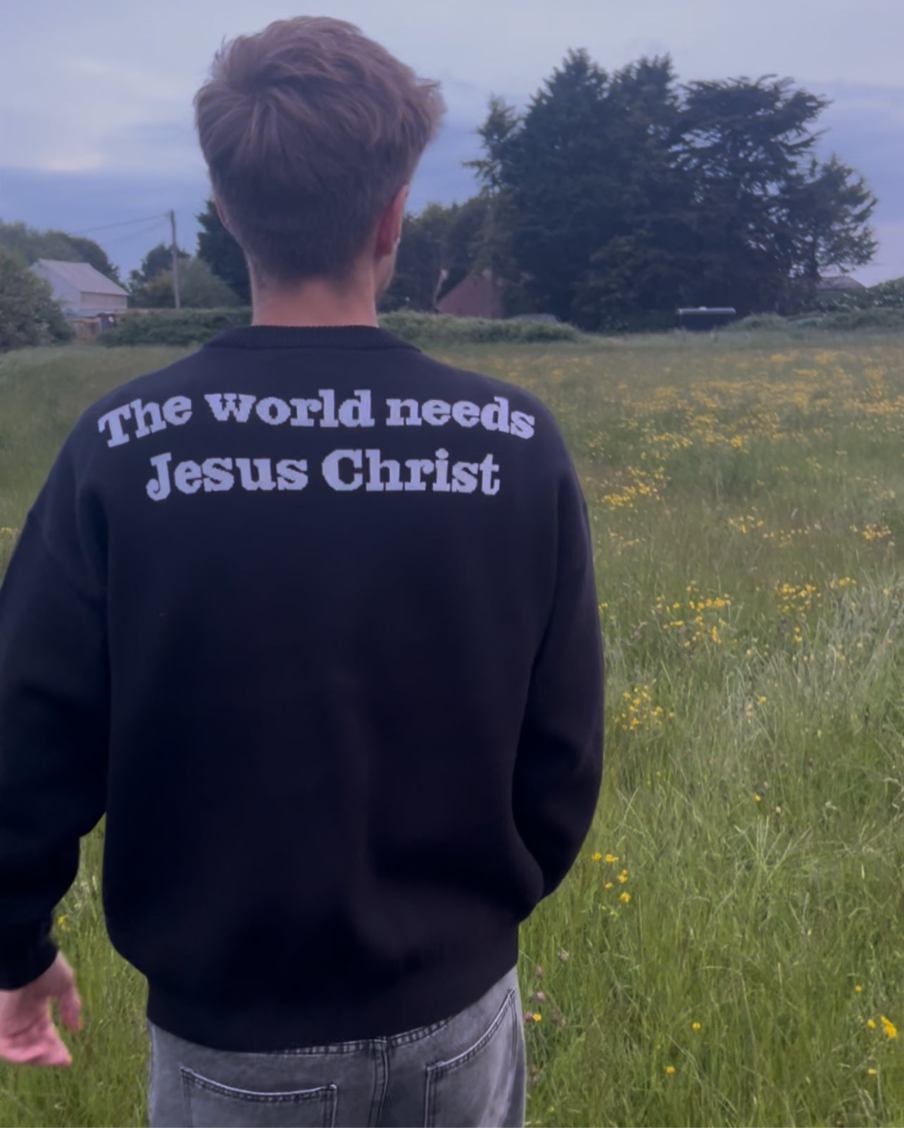 "THE WORLD NEEDS JESUS CHRIST" KNIT BLACK SWEATER